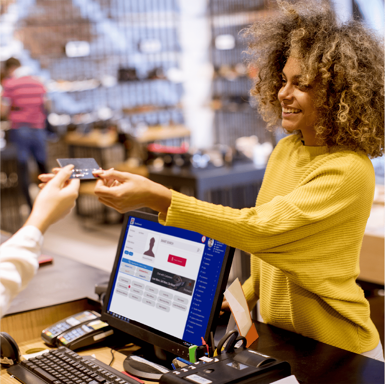 woman paying in store with bravo on monitor